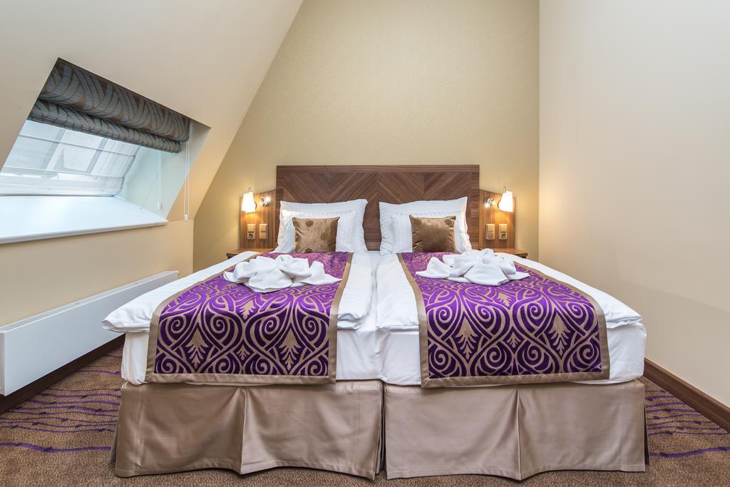 Merchants Crown Suites And Spa Prague Exterior photo A bed with a bed skirt
