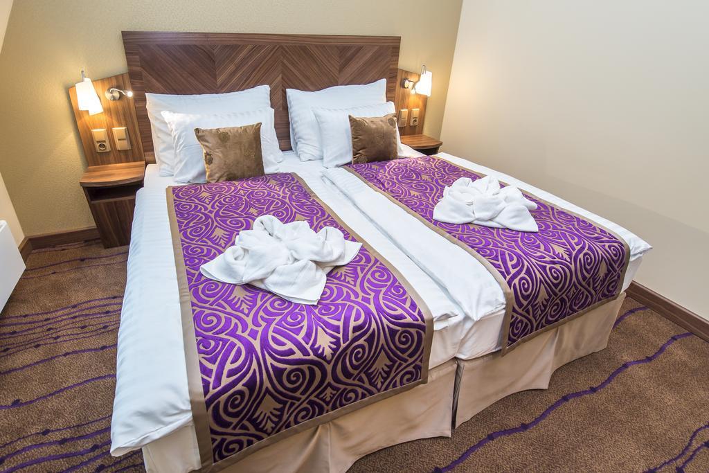 Merchants Crown Suites And Spa Prague Exterior photo A bed with a bed skirt